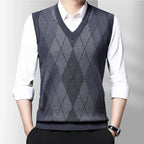 Men's sleeveless argyle V-neck sweater vest layered over a white shirt