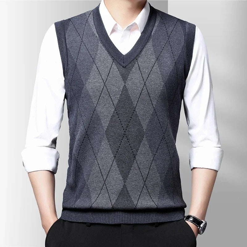 Men's sleeveless argyle V-neck sweater vest layered over a white shirt