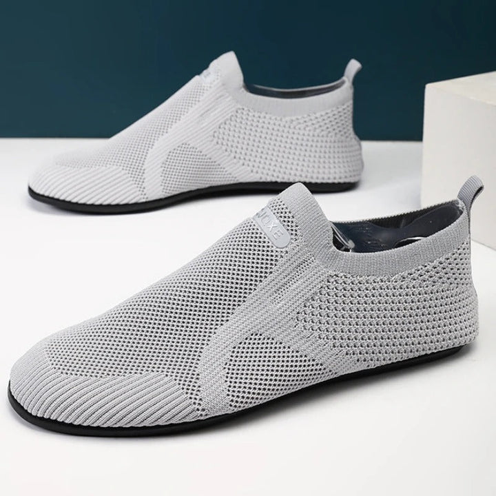 Knit barefoot-style slip-on shoes with textured panels and pull tabs