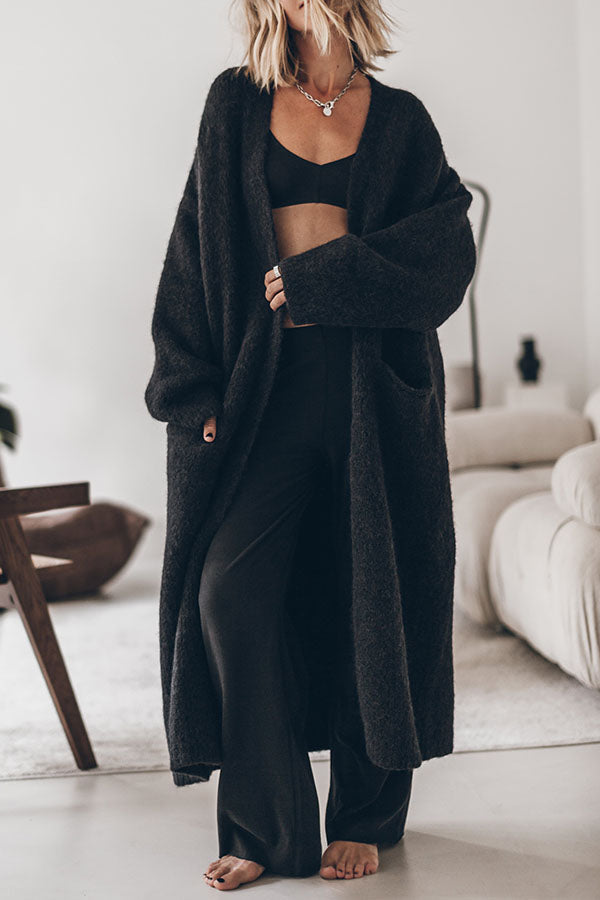 Women's oversized open front knit midi cardigan with long sleeves and front pockets