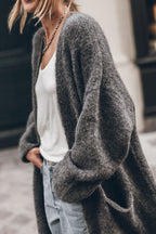 Women's oversized open front knit midi cardigan with long sleeves and front pockets
