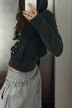 Women's black fitted hoodie with studded front trims and zip fastening