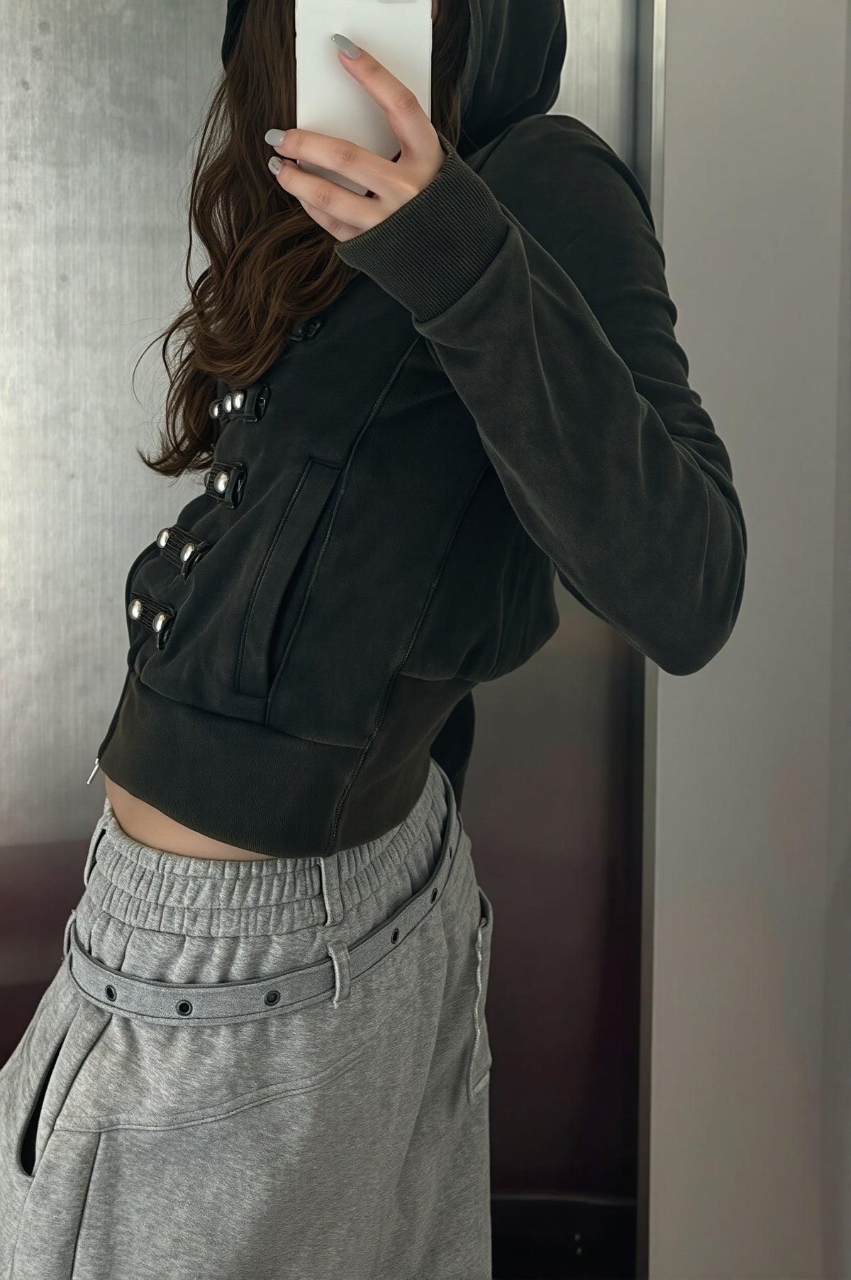 Women's black fitted hoodie with studded front trims and zip fastening