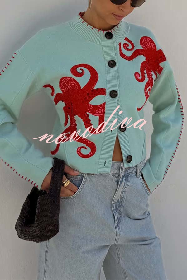 Women's pale blue cardigan with red octopus graphics and button front