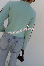 Women's pale blue cardigan with red octopus graphics and button front