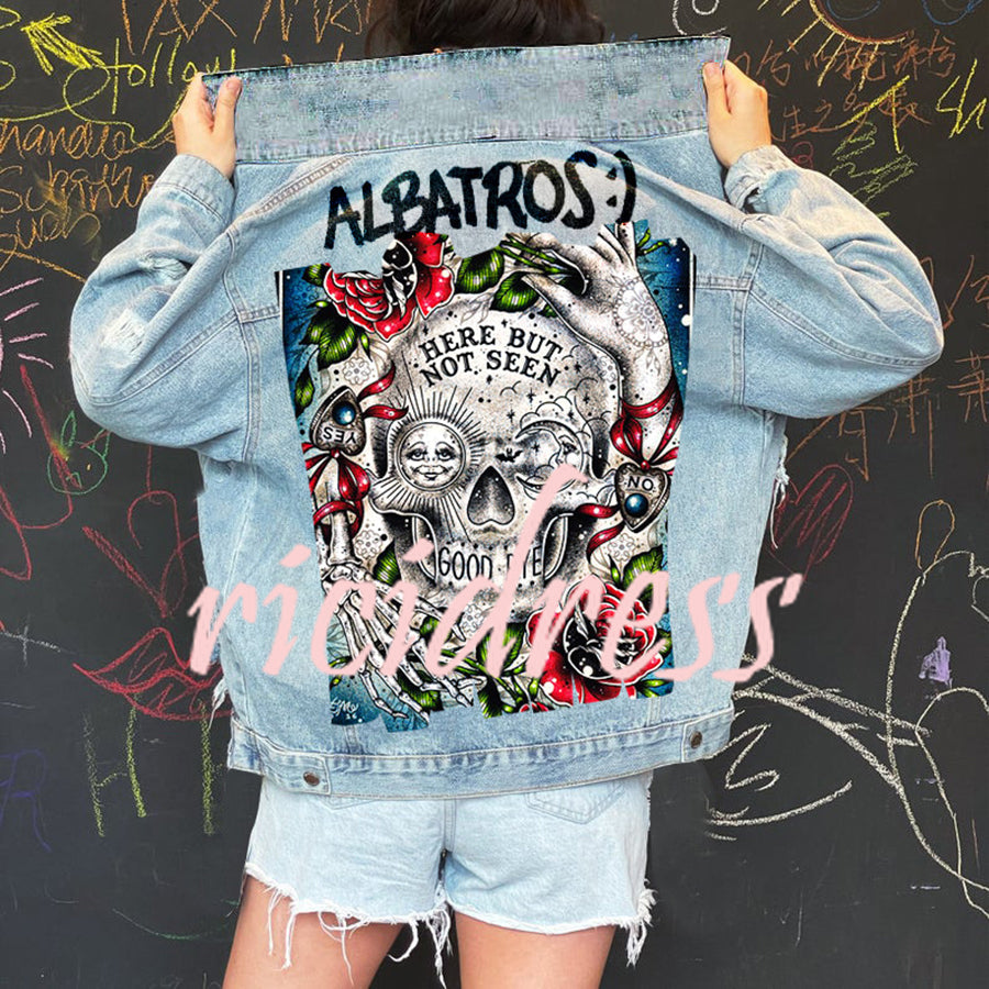 Women's light blue denim jacket with Halloween skull and rose graphic on the back