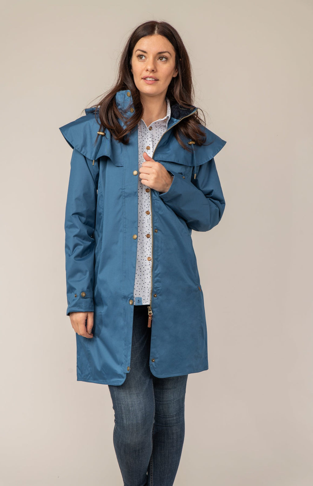 Women's hooded long raincoat with cape overlay and button front