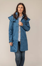 Women's hooded long raincoat with cape overlay and button front