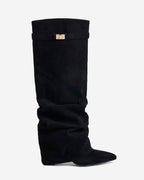 Women's black slouchy knee-high boots with pointed toes and buckled straps