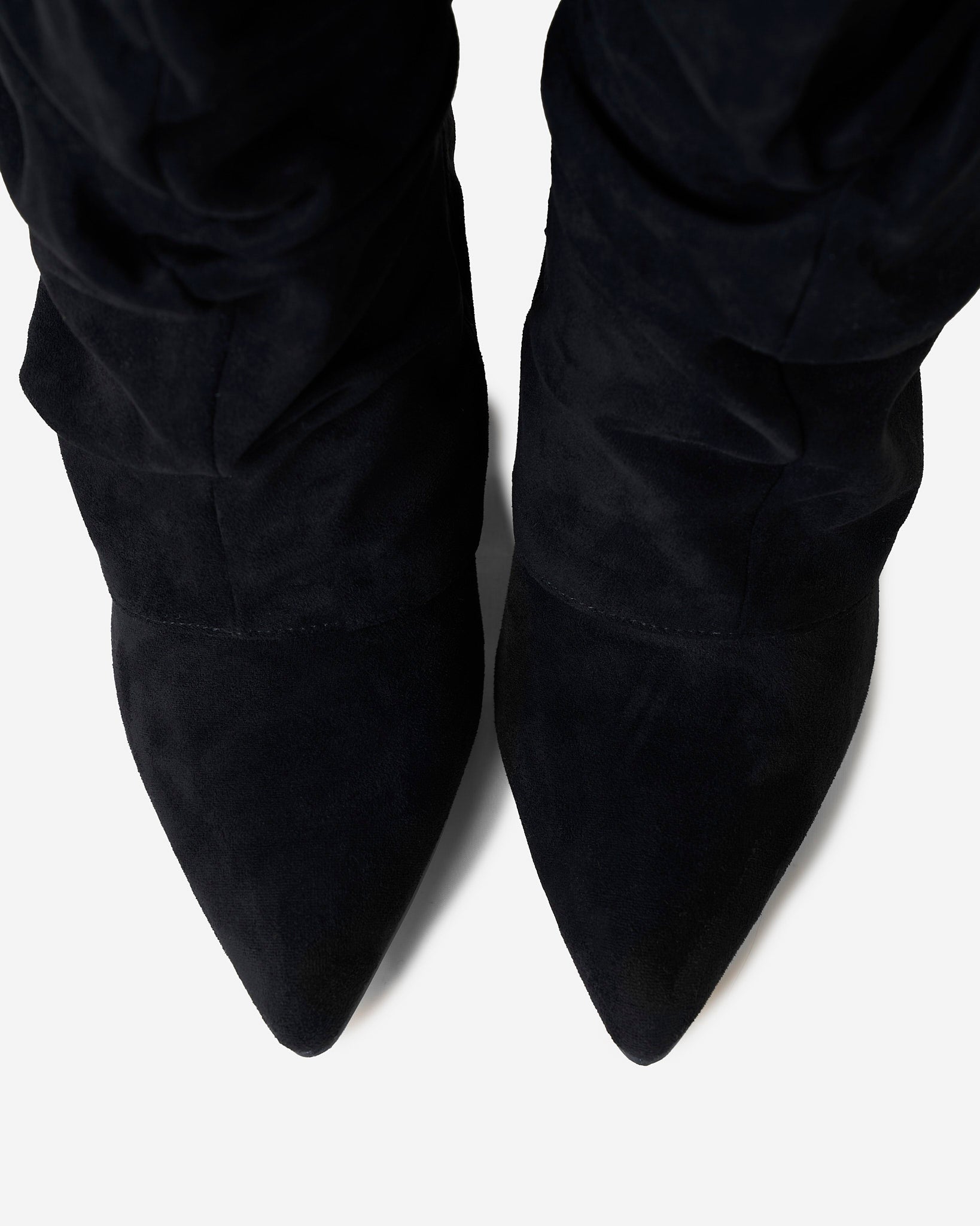 Women's black slouchy knee-high boots with pointed toes and buckled straps