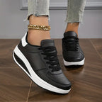 Women's low-top lace-up sneaker with printed symbols, round toe and white sole