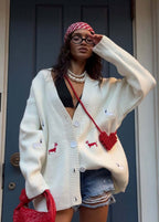 Women's oversized cable knit cardigan with buttons and embroidered motifs