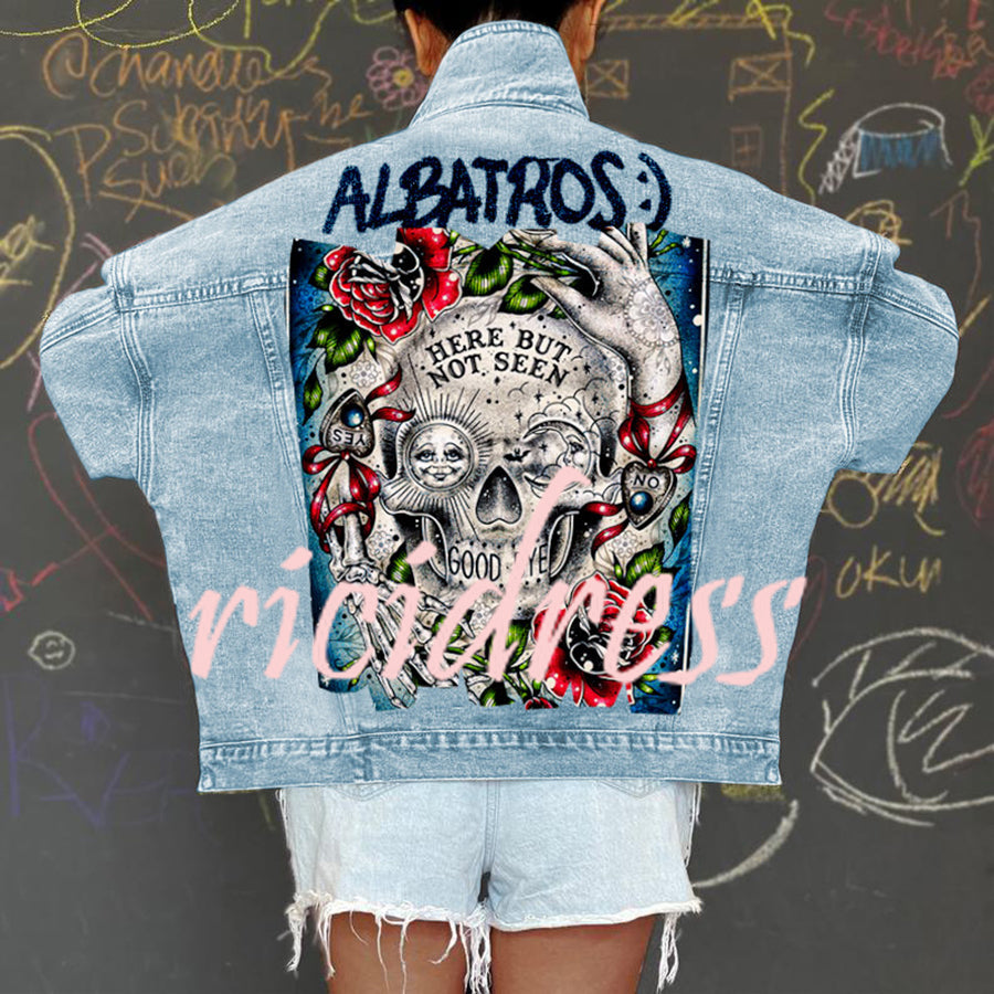 Women's light blue denim jacket with Halloween skull and rose graphic on the back