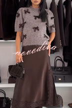 Women's brown knit crop top with dark bow details and short sleeves