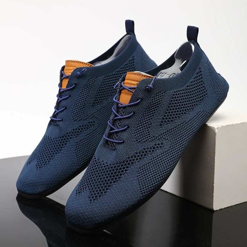 Knit sneakers with lace-up fronts, round toes and pull tabs