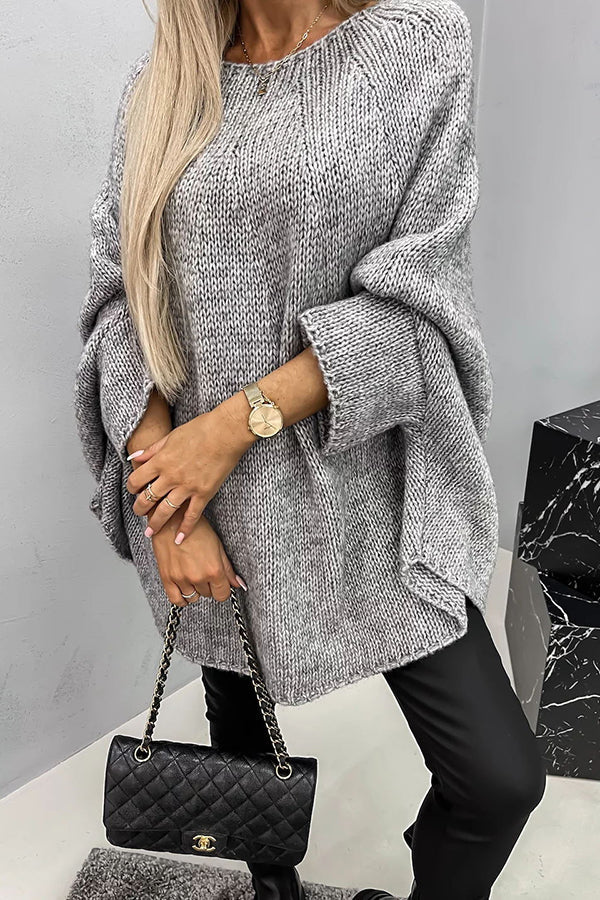 Women's loose knit poncho sweater with crew neckline and wide sleeves