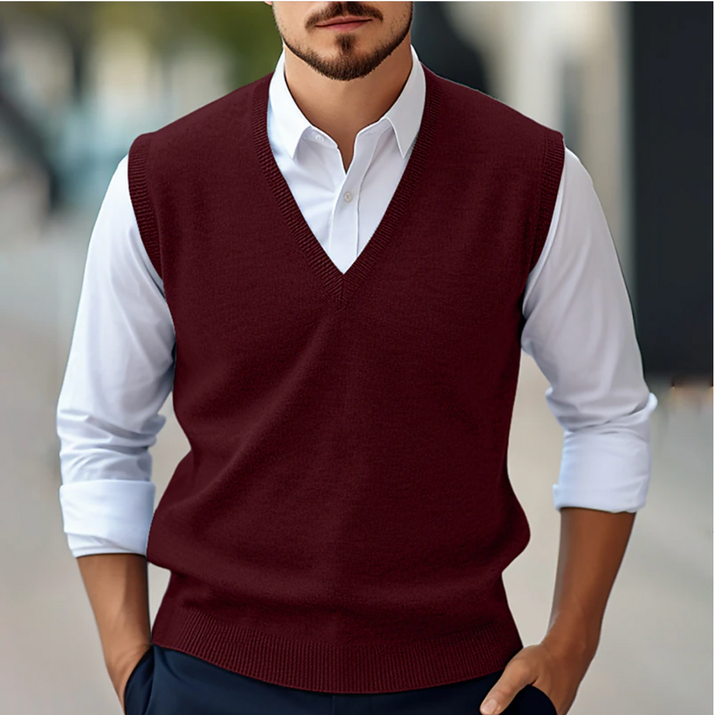 Men's sleeveless V-neck sweater vest layered over a white shirt