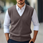 Men's sleeveless V-neck sweater vest layered over a white shirt