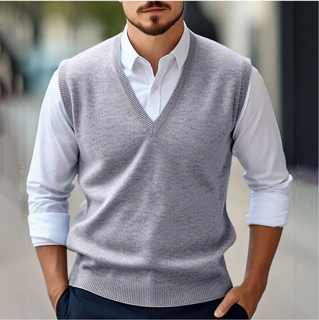 Men's sleeveless V-neck sweater vest layered over a white shirt