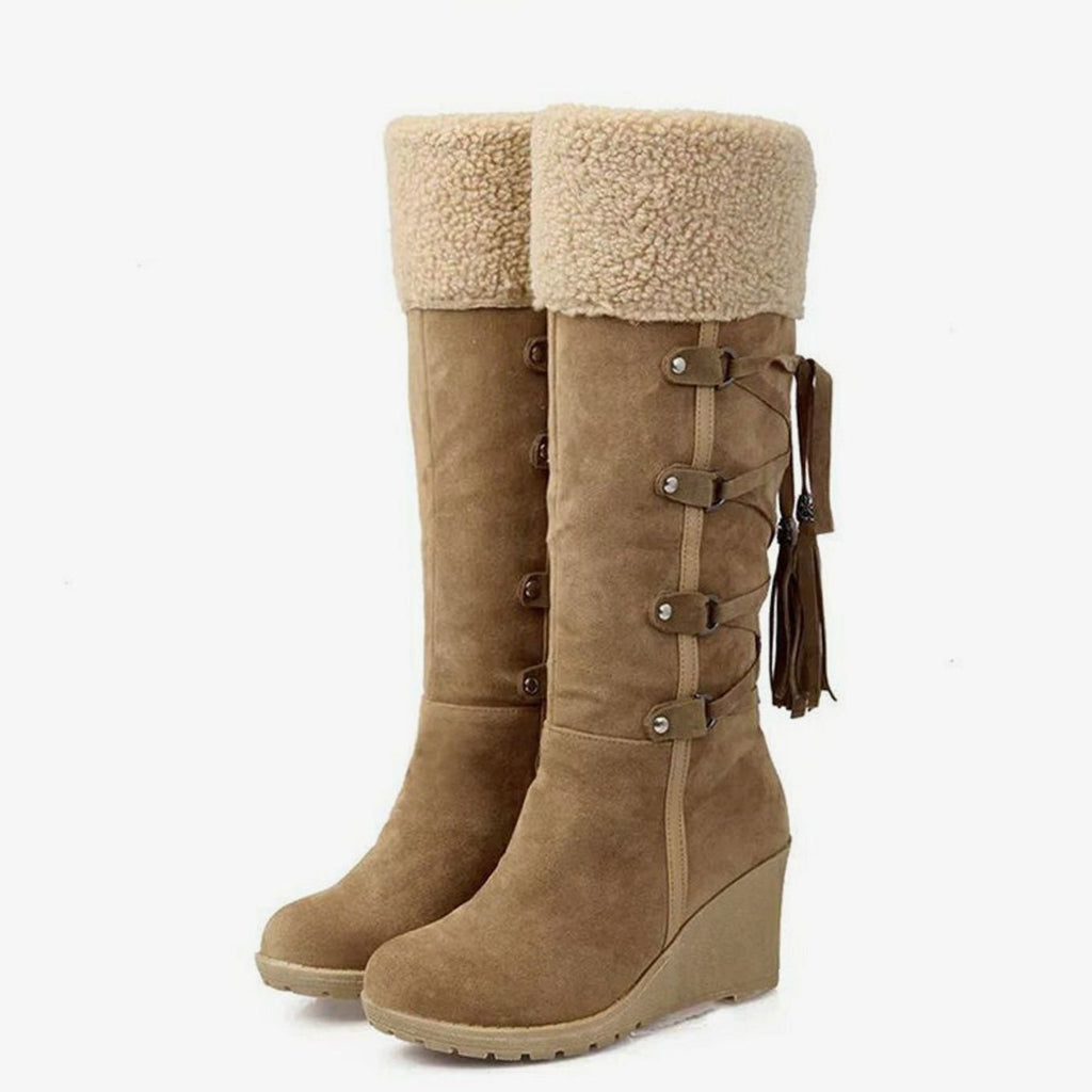 Women's knee-high wedge boots with fur-look trim, buckles and tassel details