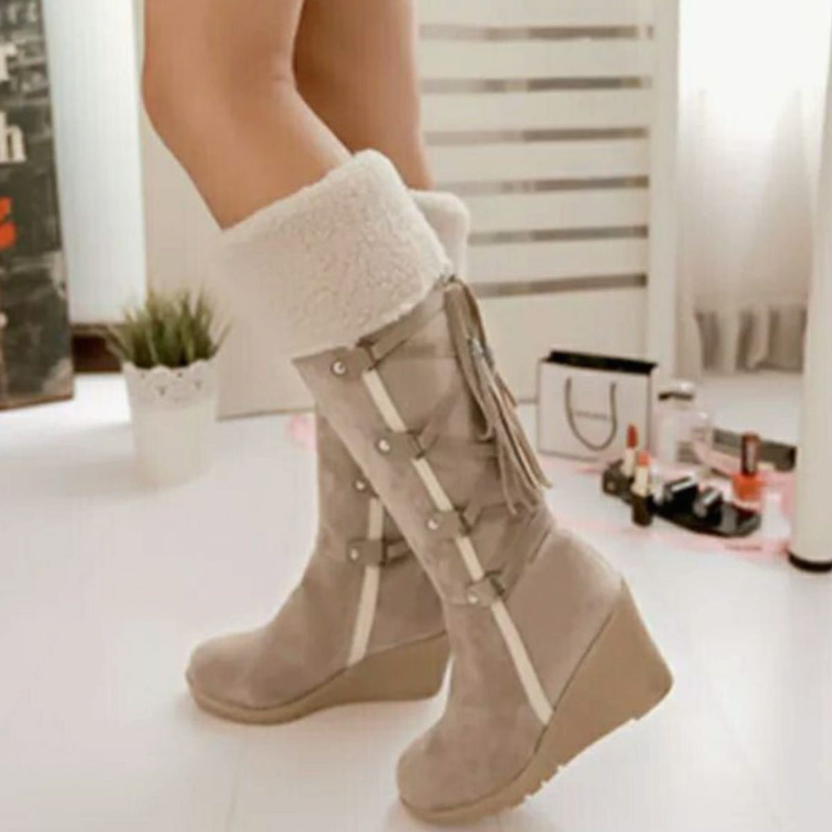 Women's knee-high wedge boots with fur-look trim, buckles and tassel details