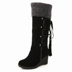Women's knee-high wedge boots with fur-look trim, buckles and tassel details