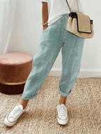 Women's cropped striped trousers with elastic waist and cuffed hems