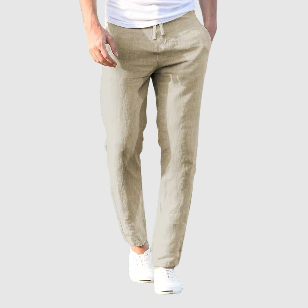 Men's beige relaxed-fit trousers with drawstring waist and flat front, full-length view.