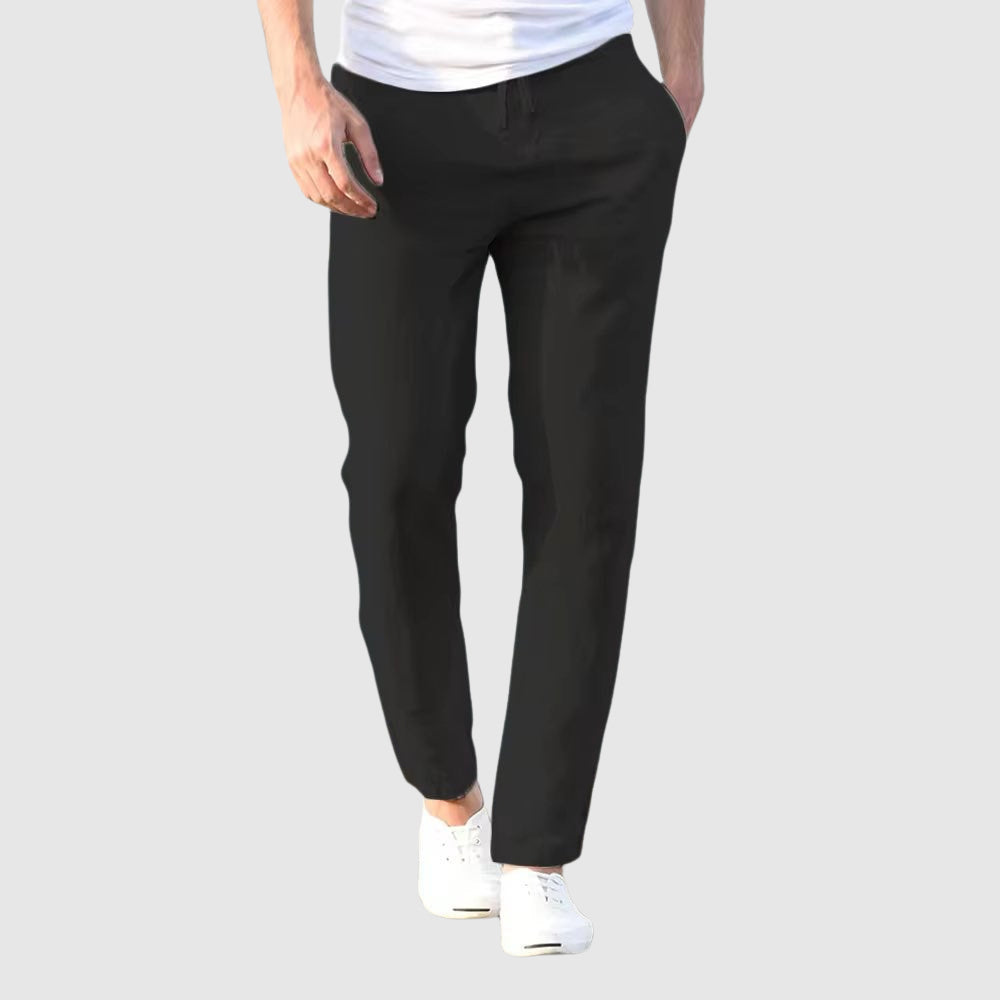 Men's beige relaxed-fit trousers with drawstring waist and flat front, full-length view.