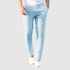 Men's beige relaxed-fit trousers with drawstring waist and flat front, full-length view.