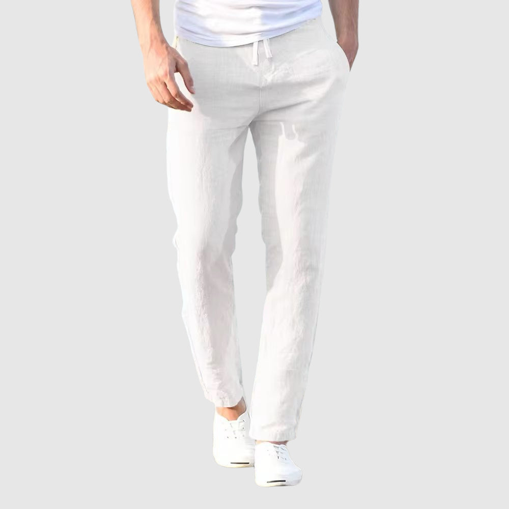 Men's beige relaxed-fit trousers with drawstring waist and flat front, full-length view.