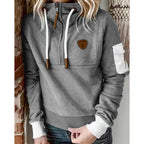 Women's hooded half-zip sweatshirt with long sleeves and utility sleeve pocket
