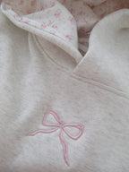 Women's cream grey hooded sweatshirt with pink bow detail