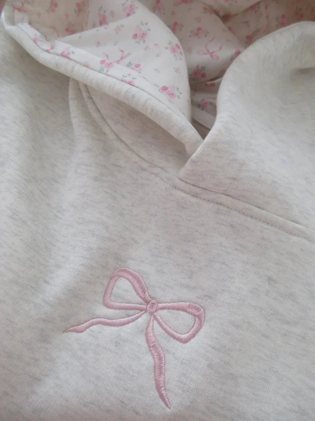 Women's cream grey hooded sweatshirt with pink bow detail