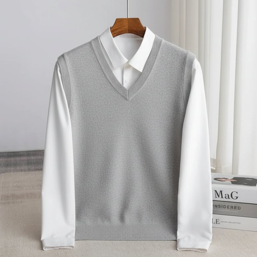 Men's V-neck knitted sweater vest layered over a white shirt