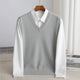 Men's V-neck knitted sweater vest layered over a white shirt