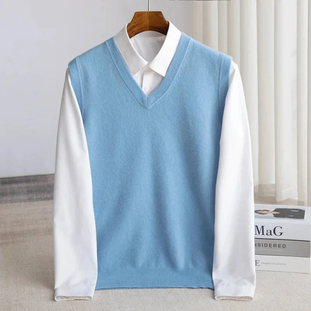 Men's V-neck knitted sweater vest layered over a white shirt