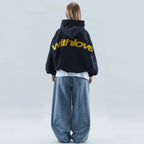 Oversized pullover hoodie with hood, long sleeves and contrasting text graphic on the back