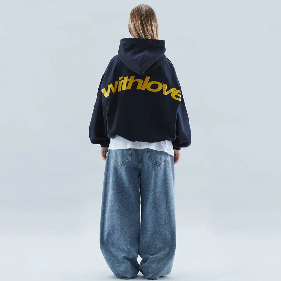 Oversized pullover hoodie with hood, long sleeves and contrasting text graphic on the back
