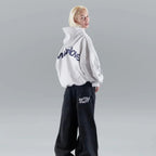 Oversized pullover hoodie with hood, long sleeves and contrasting text graphic on the back