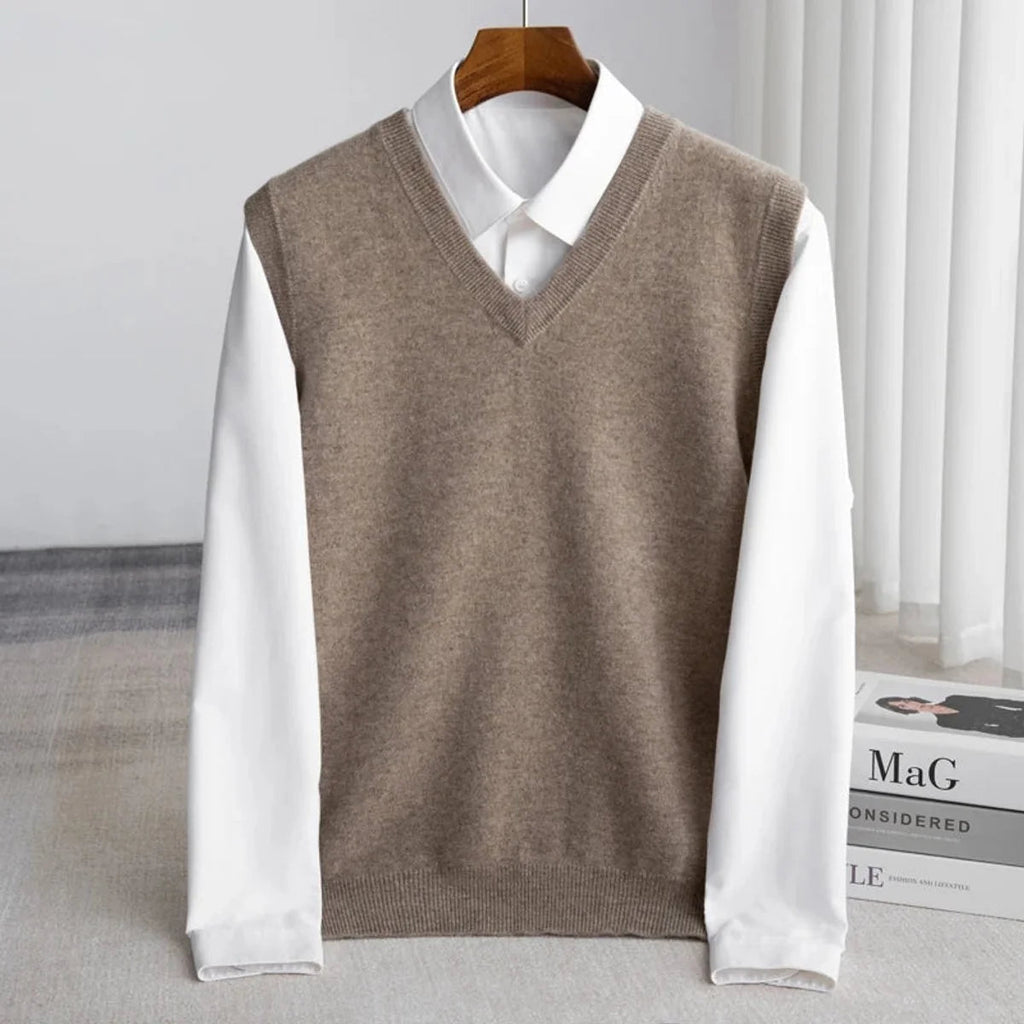 Men's V-neck knitted sweater vest layered over a white shirt