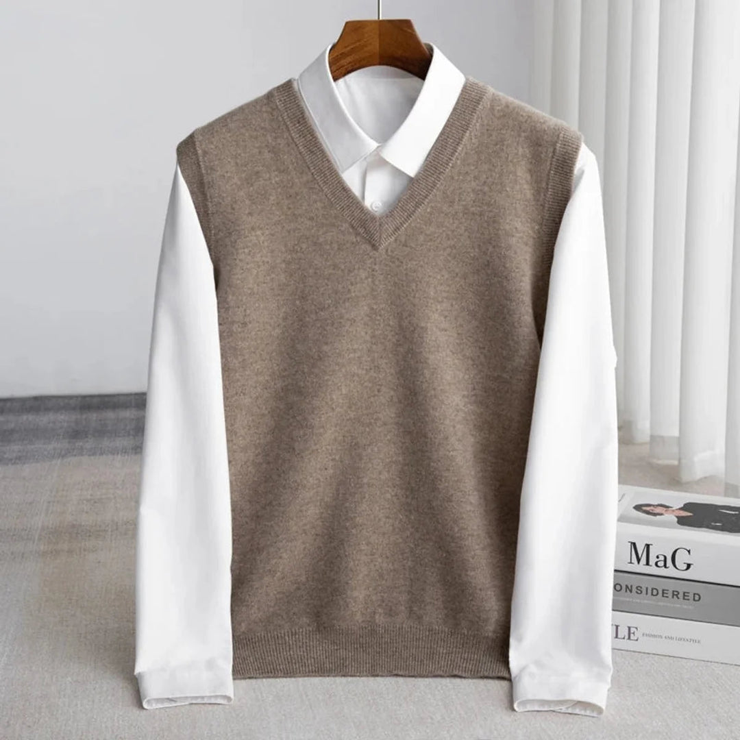 Men's V-neck knitted sweater vest layered over a white shirt