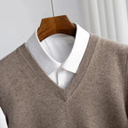Men's V-neck knitted sweater vest layered over a white shirt
