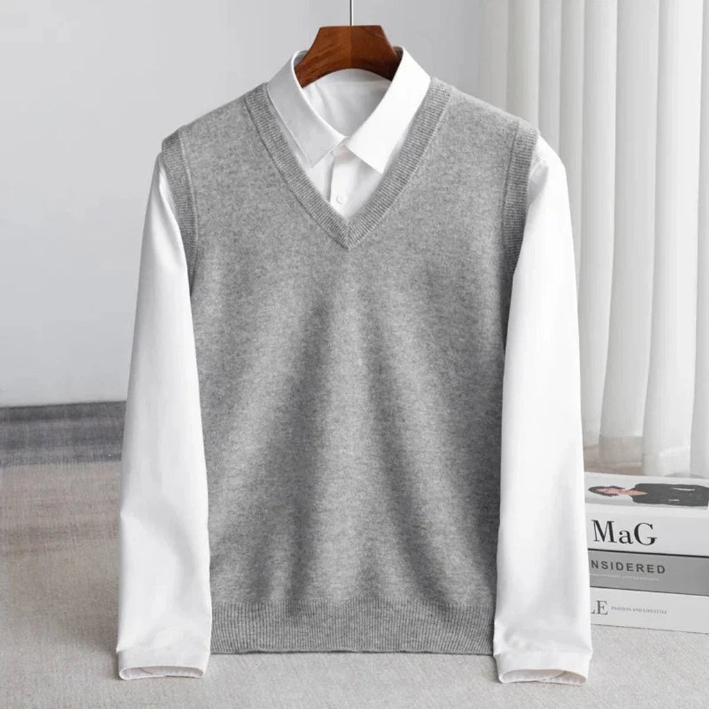 Men's V-neck knitted sweater vest layered over a white shirt