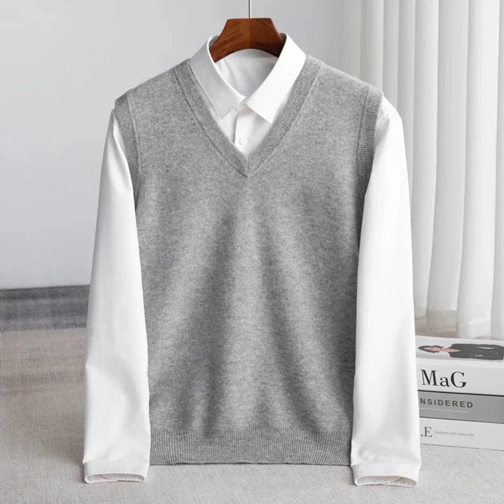 Men's V-neck knitted sweater vest layered over a white shirt