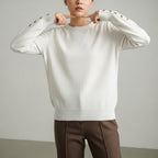 Women's long sleeve crew neck sweater with button details
