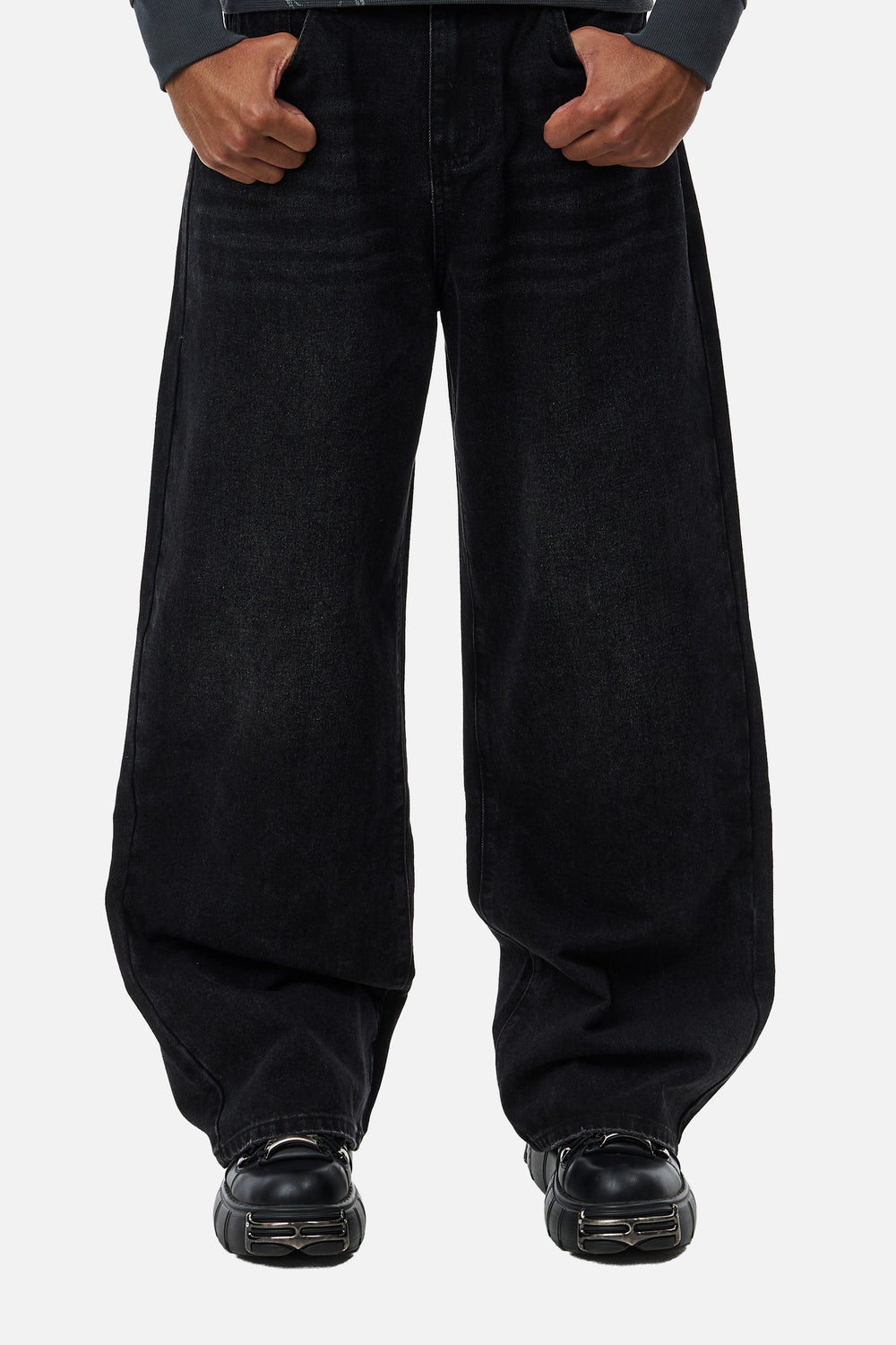 Men's black wide-leg jeans with graphic back pockets and gathered hems
