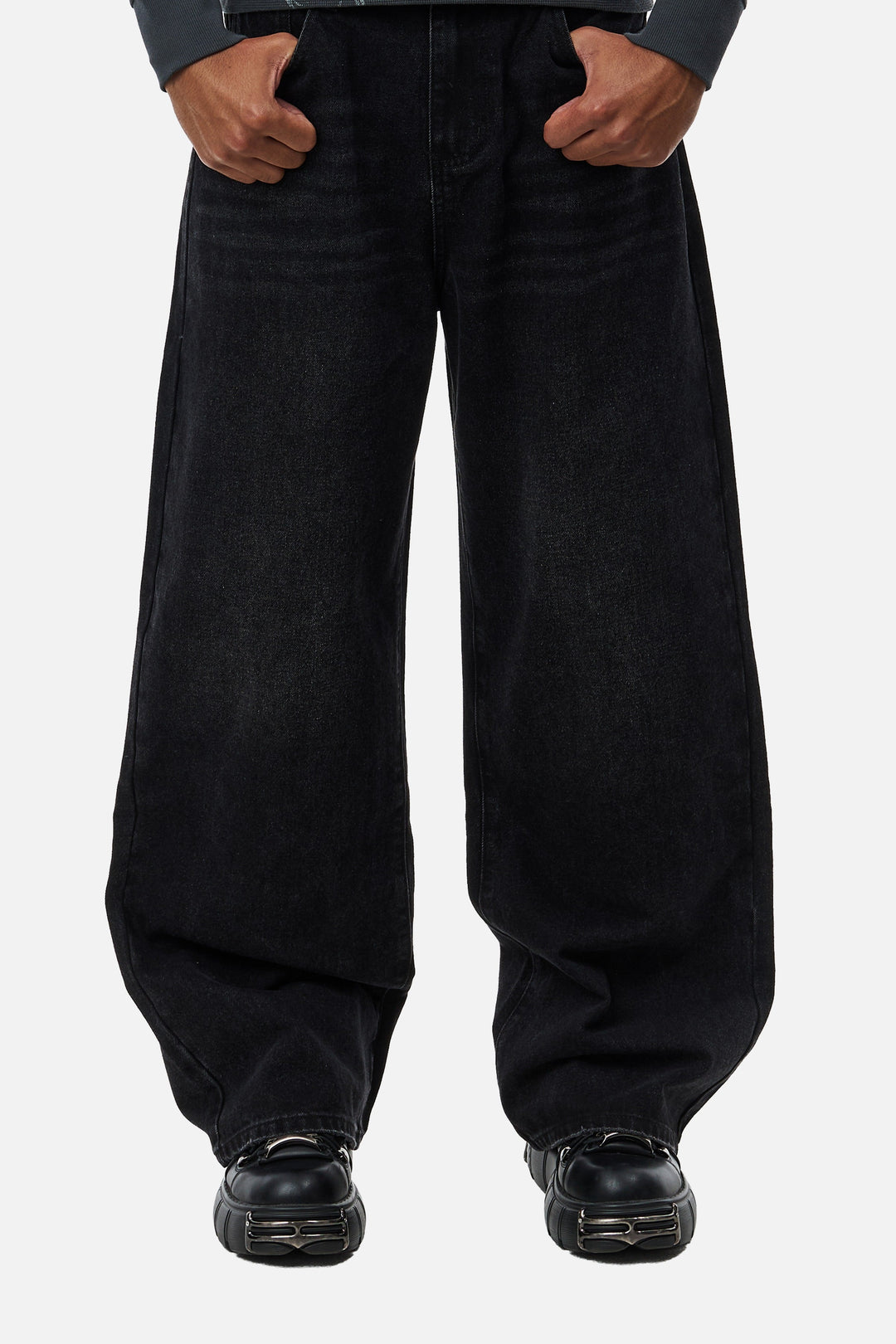 Men's black wide-leg jeans with graphic back pockets and gathered hems