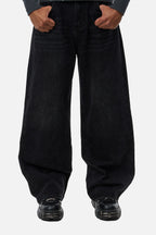 Men's black wide-leg jeans with graphic back pockets and gathered hems