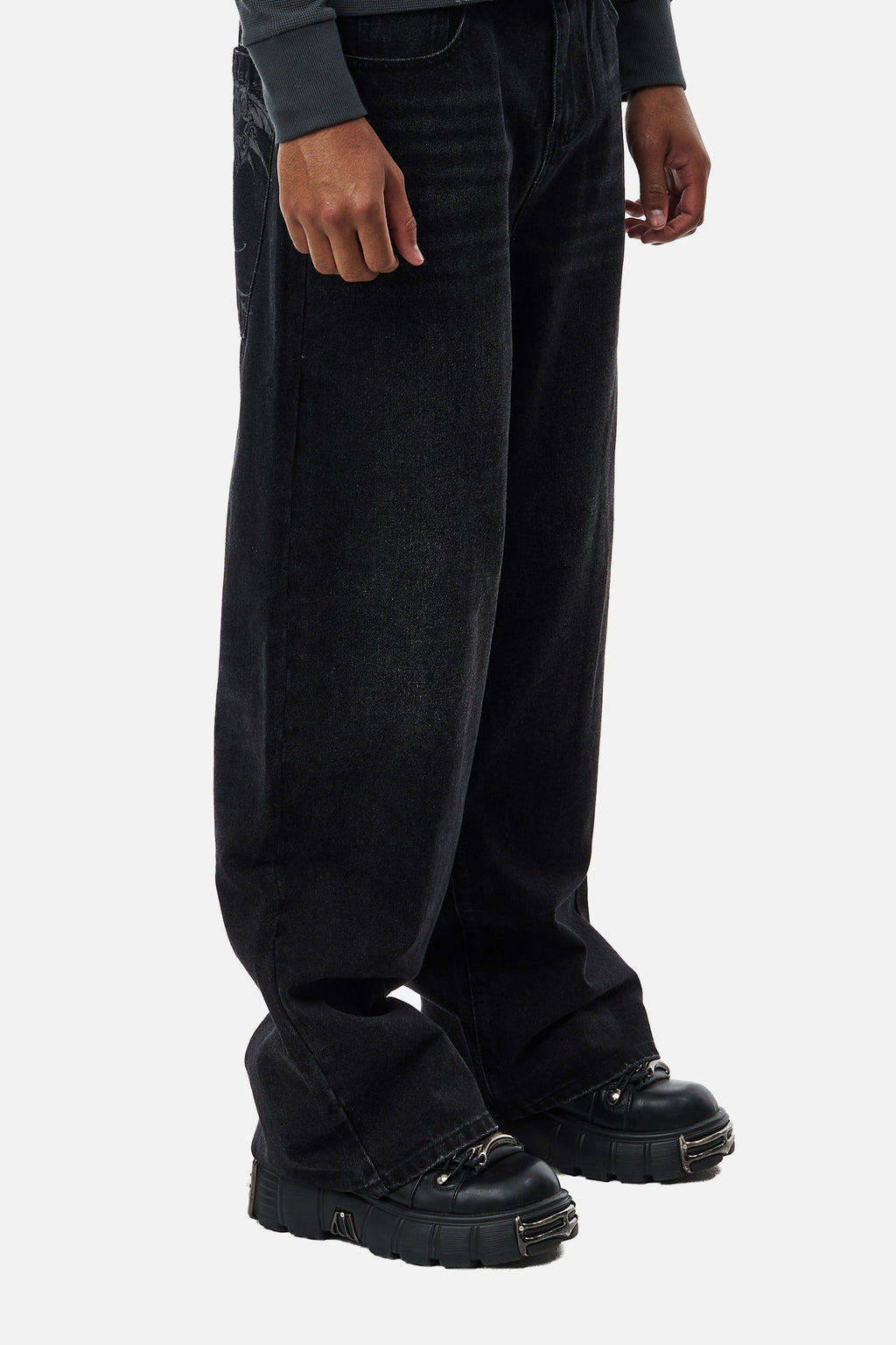 Men's black wide-leg jeans with graphic back pockets and gathered hems